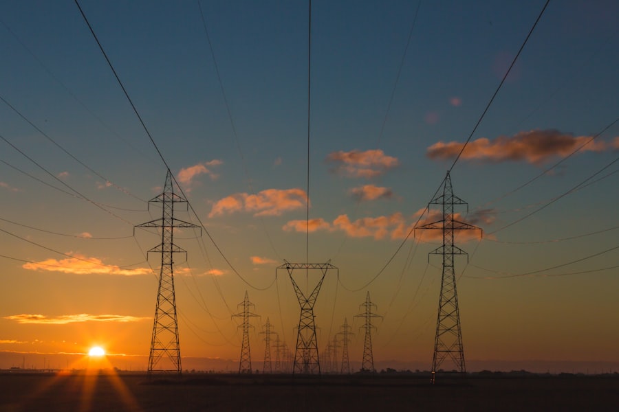 High-voltage power lines and pylons at sunset